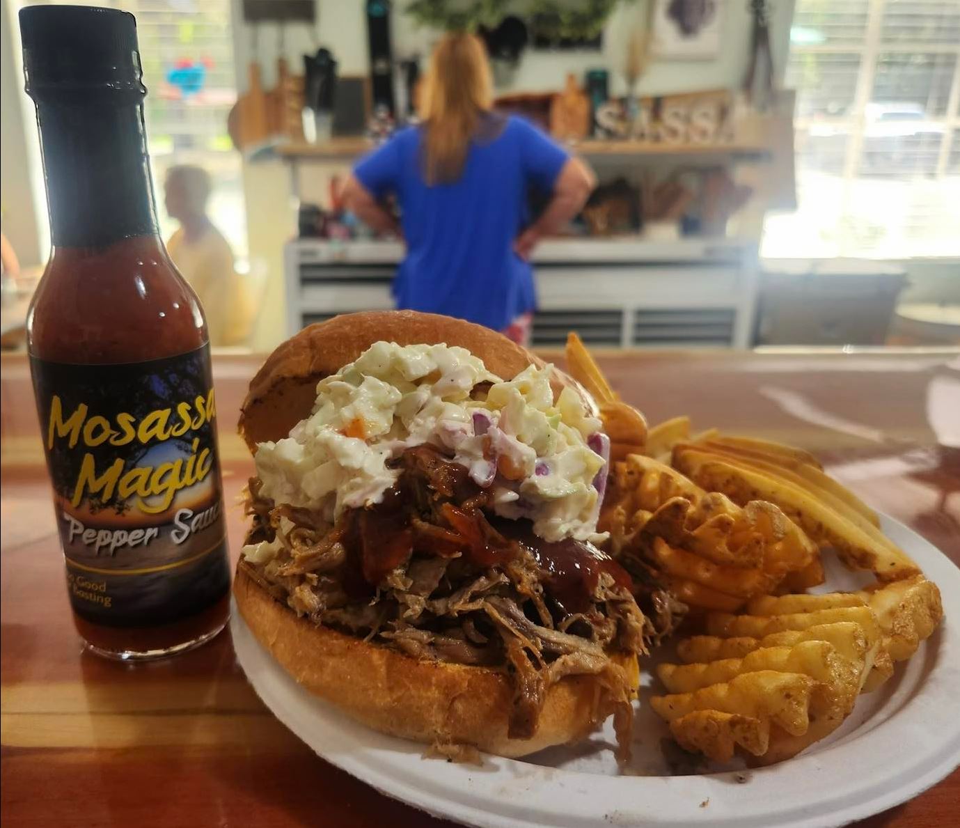 Dive into this scrumptious pulled pork sandwich featuring Mosassa Magic Pepper Sauce.